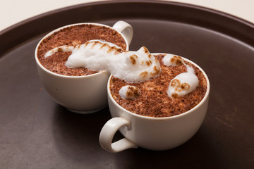 Coffee with foam in the form of cat and mouse