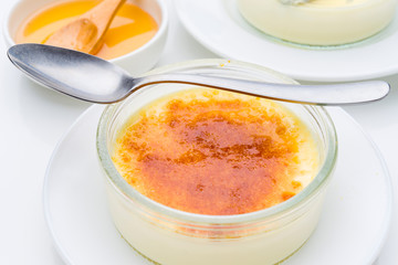 teaspoon on homemade creme brulee with burnt sugar, isolated