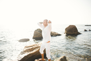Portrait of a handsome young man in the sun by the sea