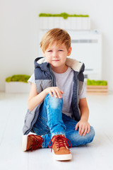 portrait of cute fashionable kid, boy sitting on the floor