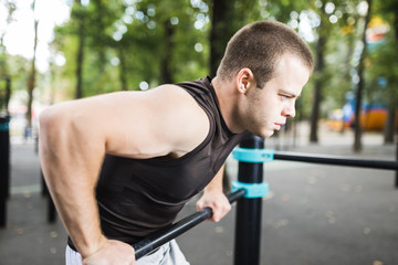 Healthy handsome active man with fit muscular body doing workout exercises