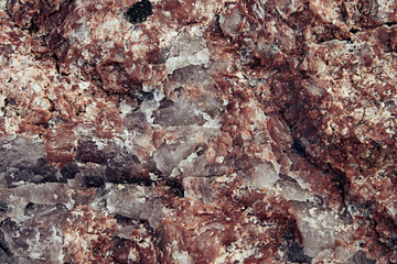 Surface of red granite close-up. Texture wild stone.