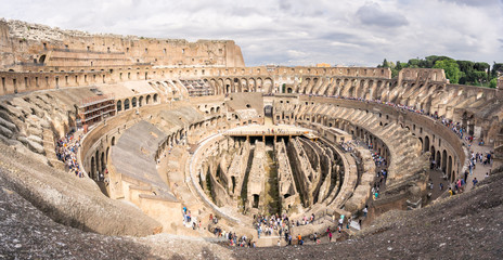 A wide view of the inside of the Coliseum in Rome from the uppermost levels, with unrecognisable...