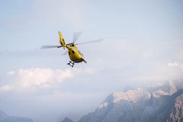 Fototapeta na wymiar Medical rescue helicopter in air. Italian Dolomites.