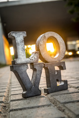 Love sign with metal letters in a street