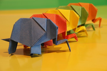 
Origami elephant out of paper isolated on a colored background