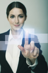 Smiling  business woman pushing on whiteboard isolate on dark ba