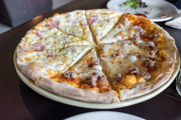 Pizza homemade fresh carbonara ham half Italian sausage on wooden table in restaurant