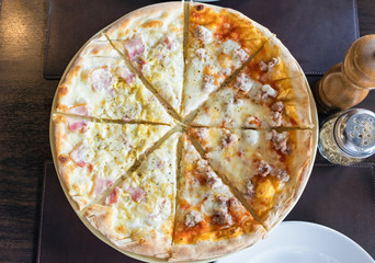 Pizza homemade fresh carbonara ham half Italian sausage on wooden table in restaurant,top view,flat
