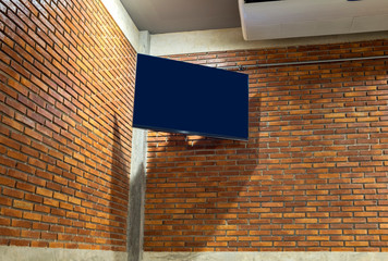 Flat screen tv on corner brick wall