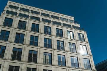 Fototapeta na wymiar grey facade with darken blue windows