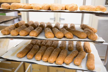 Shelves with baked French baguettes at bakery display