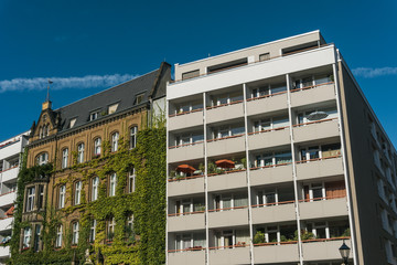 plattenbau building next to old fashioned building