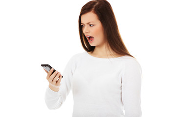 Young student woman yelling to the mobile phone