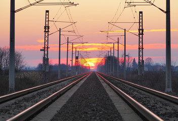 Obraz na płótnie Canvas Railroad - Railway at sunset with sun