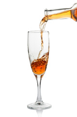 White wine pouring in goblet closeup