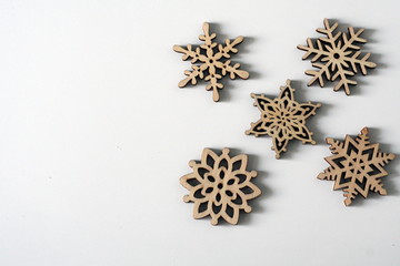 Wooden christmas ornaments on white background with copy space
