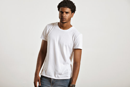 Anxious looking sexy young African American in blank white sleeveless t-shirt looking into the camera
