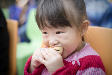 Little girl eating bread