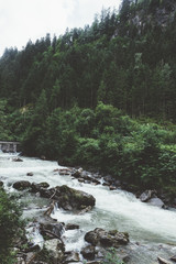 Waterfalls and river by the mountains with trees - 121797044