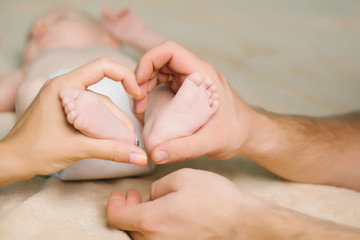 Newborn feet in parent hands