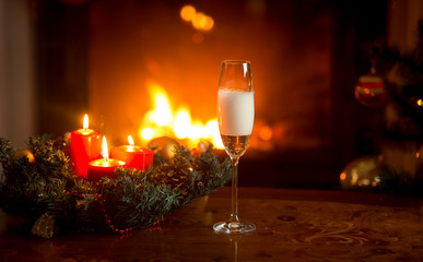 Pouring fizzy champagne in crystal glass on table decorated for