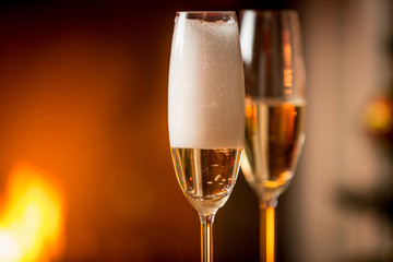 Closeup image of foam in glasses filled with champagne with burn