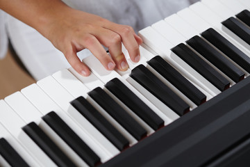 female's  hands playing piano