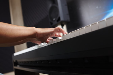 female's  hands playing piano