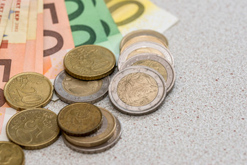 euro banknotes with coins on desk