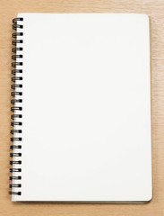 white blank notebook on the table, space for text