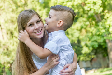 Fototapeta premium outdoor portrait of young handsome child boy with his mother