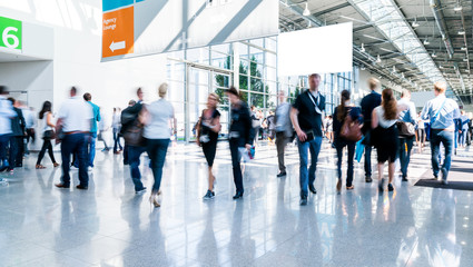 blurred people walking in a modern hall