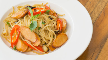 Spaghetti seafood on the dish on the wood table