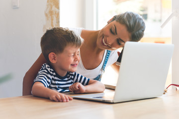 Mother and son playing on a computer