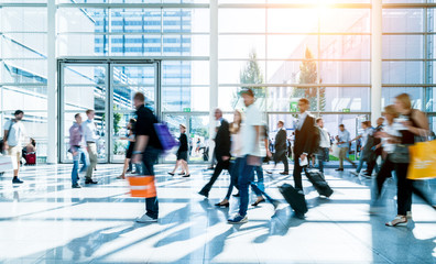 blurred people walking in a modern hall