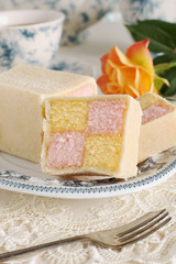 Battenberg Cake or Battenberg Square a sponge cake with pink a yellow checks covered in marzipan