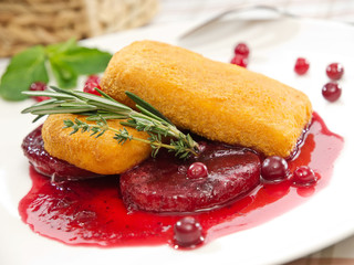 deep fry camembert with cranberries and berry sauce, close up view