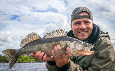 Angler with zander fishing trophy