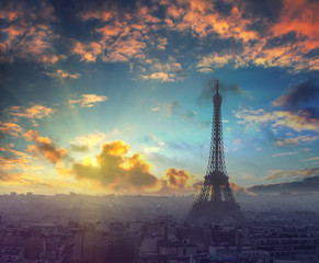 Beautiful sunset and dramatic sky above the Paris, France with Eiffel tower in autumn time at evening. Vintage style travel background