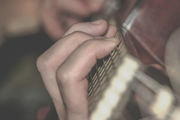 Fingers on guitar neck