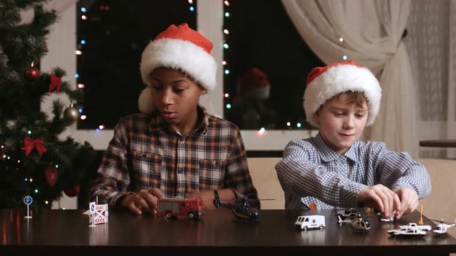 Kids with toy cars. Two boys in Christmas hats. Best holiday presents. Santa knew what I wanted.