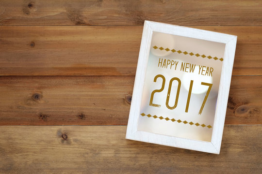 Happy new year 2017 on white vintage wooden frame background