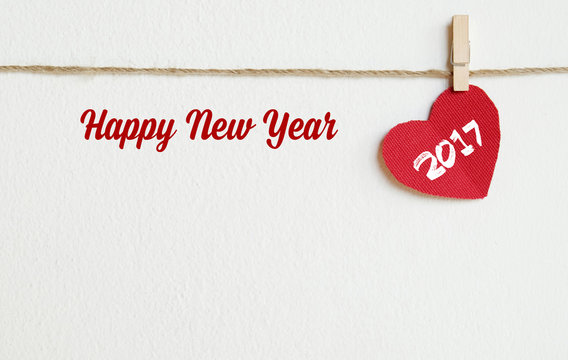Red fabric heart with 2017 and happy new year word on white wall