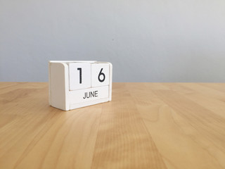 June 16th.June 16 white wooden calendar on vintage wood abstract