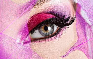female eye with  beautiful fashion bright pink makeup
