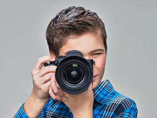 Boy with photo camera taking pictures.