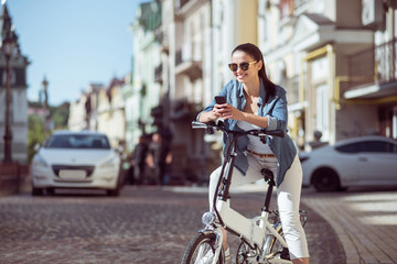 Fototapeta na wymiar Positive woman riding a bicycle