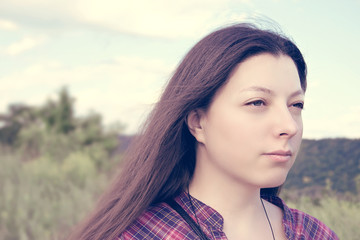 Portrait of an young beautiful woman on the nature.