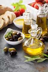 Olive oil in vintage bottles and italian cuisine ingredients